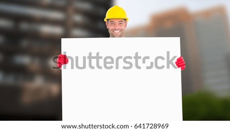 Digital composite of Portrait of smiling male architect holding blank card