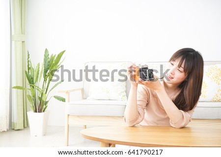 Young woman using  camera 