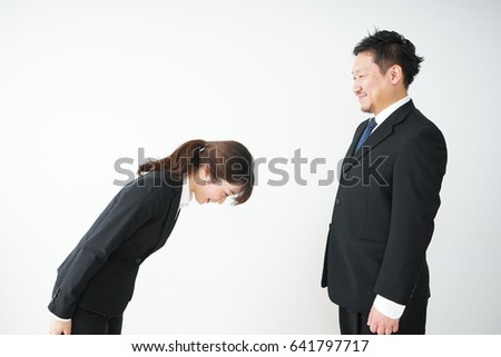 A bowing business person