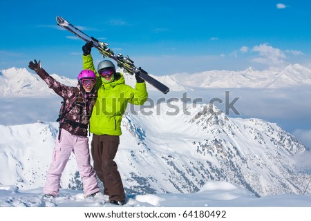 Young happy couple in snowy mountains. Winter sport vacation Royalty-Free Stock Photo #64180492