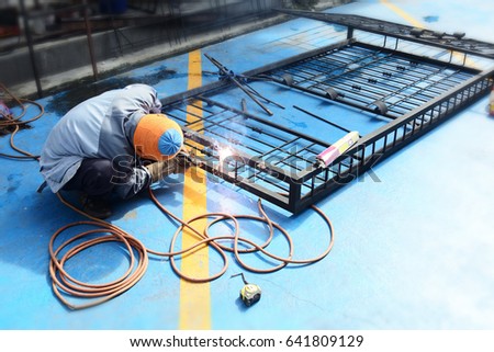 welder is welding iron window Royalty-Free Stock Photo #641809129