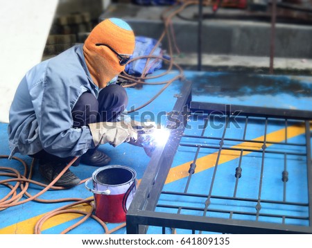 welder is welding iron window Royalty-Free Stock Photo #641809135