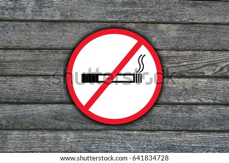 Smoking is forbidden sign with with grey wooden background
