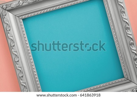 Abstract composition of blue and pink paper, a silver picture frame. Creative background.