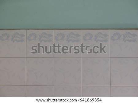 tiled surface in kitchen white ceramic tiles and blue background