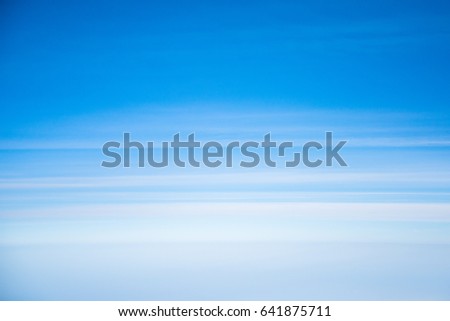 Blue sky with linear soft clouds (view from airplane)