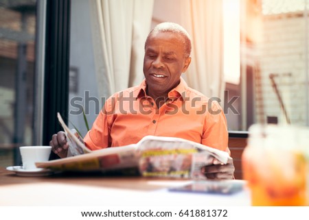 Businessman having coffee with newspaper
