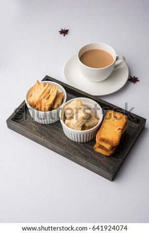 indian khari or kharee or salty Puff Pastry Snacks and tutti frutti toast, served with indian hot tea, selective focus texture