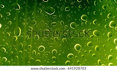 beautiful nature of raindrop on the window with soft focus green color background and texture