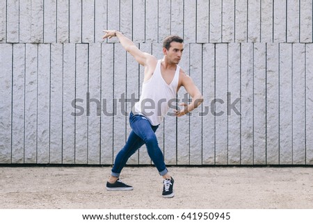 latin male dancer on casual clothes performing on the street