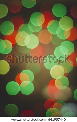 Green and red bokeh on a black background