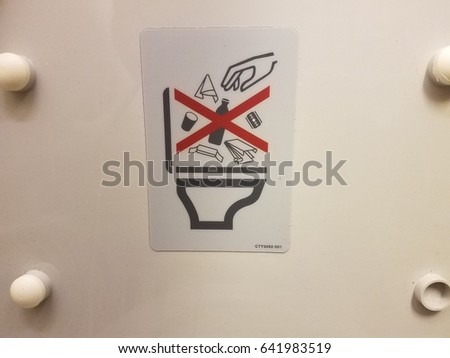 no trash in toilet sign in airplane bathroom