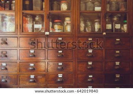 old herbal medical shop retro Chinese style seasoning collection wood cabinet in herb store. Royalty-Free Stock Photo #642019840