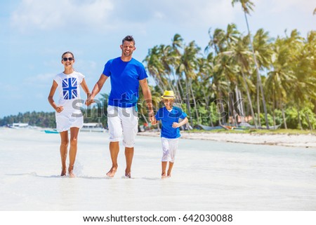 Happy kids with father having fun on tropical beach