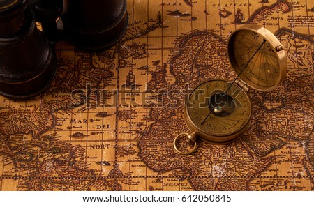 Old vintage retro compass on ancient world map. Vintage still life. Travel geography navigation concept background.