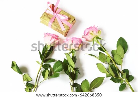 Happy bday wishes greeting card for woman. Bouquet of three pink roses and a gift box for a woman. Conception of congratulations for Birthday, Valentine's Day. Flatlays, top view photography