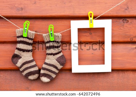 Grandparent day. Knitted striped socks on wooden brown background. Home decoration. Mothers day. Oh happy day. Space for photo and mock up.