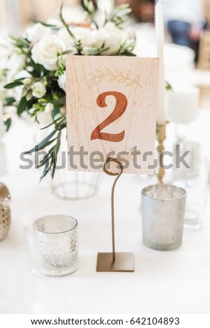 Number on a table in restaurant. Festive banquet. Royalty-Free Stock Photo #642104893