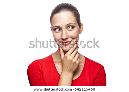 Portrait of thoughtful happy woman in red t-shirt with freckles, studio shot. isolated on white background. 