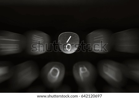 Digit on black key on retro typewriter with blur background
