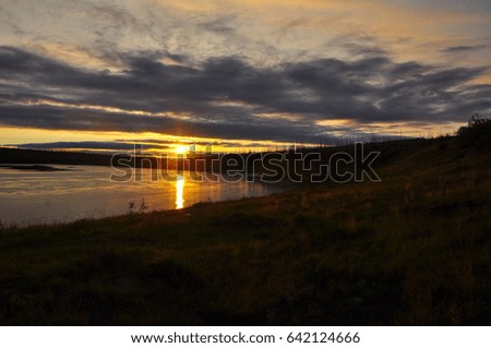 Sunset on the North river. Evening summer landscape of Taimyr.