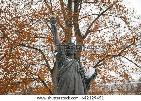 Statue of Liberty with big autumn trees in the background