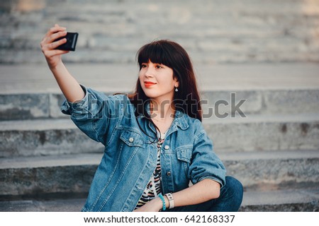 youn girl walking in the park make selfie have fun