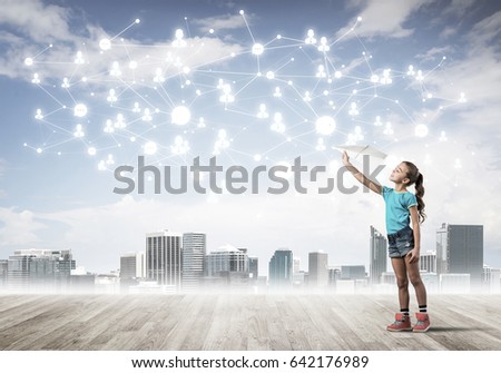 Cute kid girl standing on wooden floor and play with plane