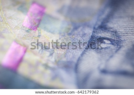 Macro detail of security thread and partial image of Nelson Mandela in obverse of South African ZAR banknote with a denomination of 100 rand