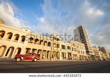 Bright scenic view of the Malecon seafront street in Havana, Cuba in the golden light of the late afternoon sun. Slow shutter speed with motion blur.