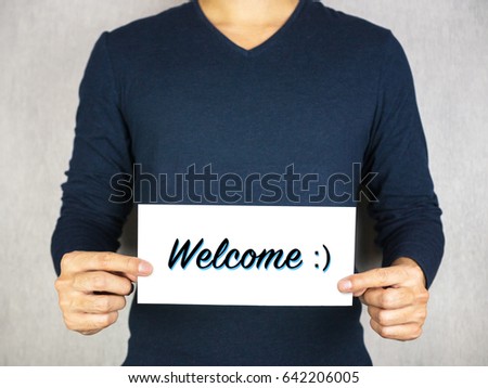 Welcome with smiley face icon sign holding by man, happy and greeting concept