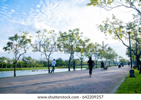 Blurred picture of people are running in the park. 
