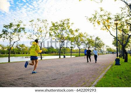 Blurred picture of people are running in the park. 

