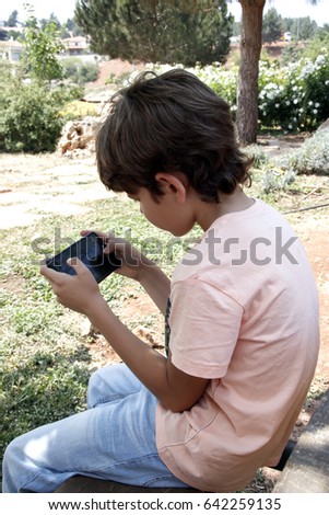 Cute little boy playing with mobile device