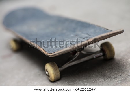 A macro shot of a used skateboard.