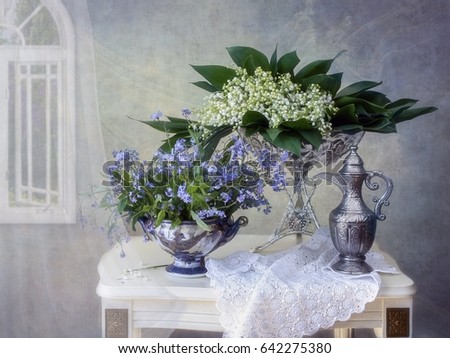 Still life with lilies of the valley and forget me not flowers