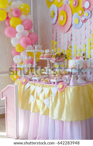 candy bar for first year birthday, candies , cakes on the table