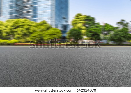 empty asphalt road front of modern buildings
