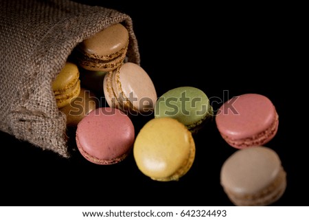 Cake macaron or macaroon isolated on black background, sweet and colorful dessert