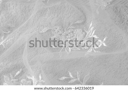 Texture, background, pattern. Lacy white fabric. Flowers made of lace fabric. White background. greeting card. Wallpaper for your desktop. Screensaver backdrop for designer