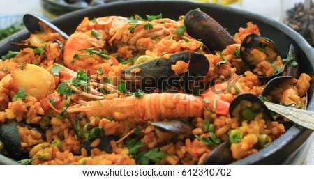 Close up view of a Spanish seafood paella: mussels, king prawns, langoustine, haddock Royalty-Free Stock Photo #642340702