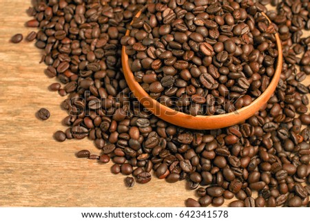 Coffee beans and wooden container with copy space.