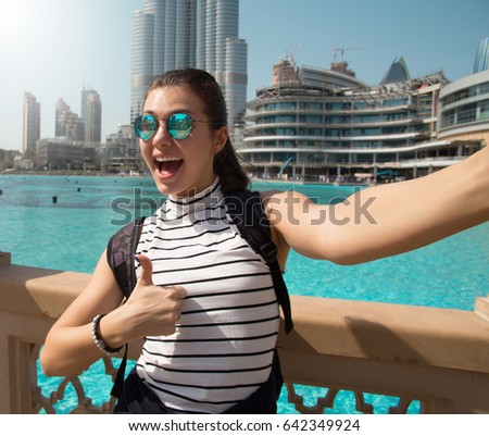 United Arab Emirates. traveler and photographer takes picture for her blog.Young happy tourist making selfie photo 