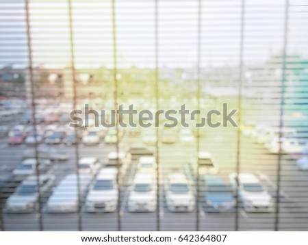 Blurred image of car at public car parking background.  vintage filter effect.