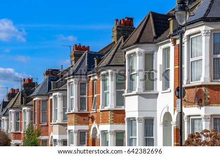 Row of typical English terraced houses in West Hampstead, London Royalty-Free Stock Photo #642382696