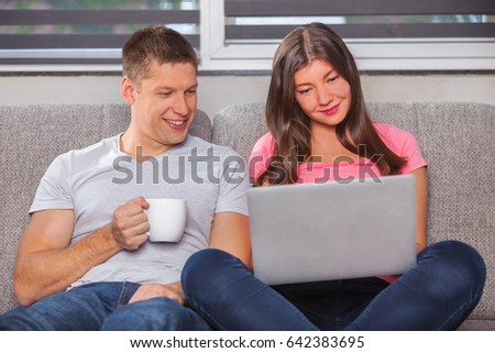 Photo of caucasian couple doing shopping online at home 
