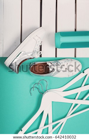 Flat Lay of Modern White Shoes. Overhead Top View Photography. Youth Lifestyle Concept. Turquoise background