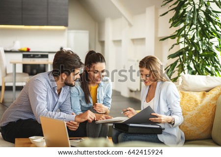 Female Real Estate agent offer home ownership and life insurance to young couple. Royalty-Free Stock Photo #642415924
