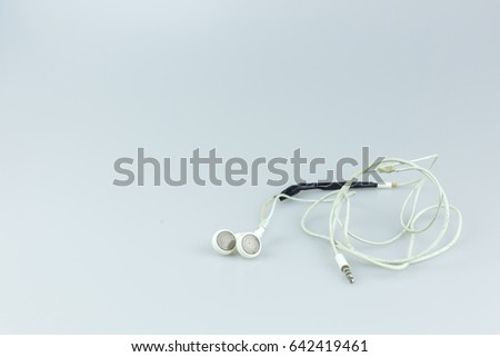 Broken earphone on white background.