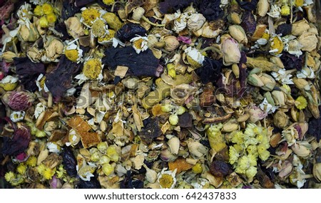 Background of dried herbal tea with chamomile and fruits of different plants